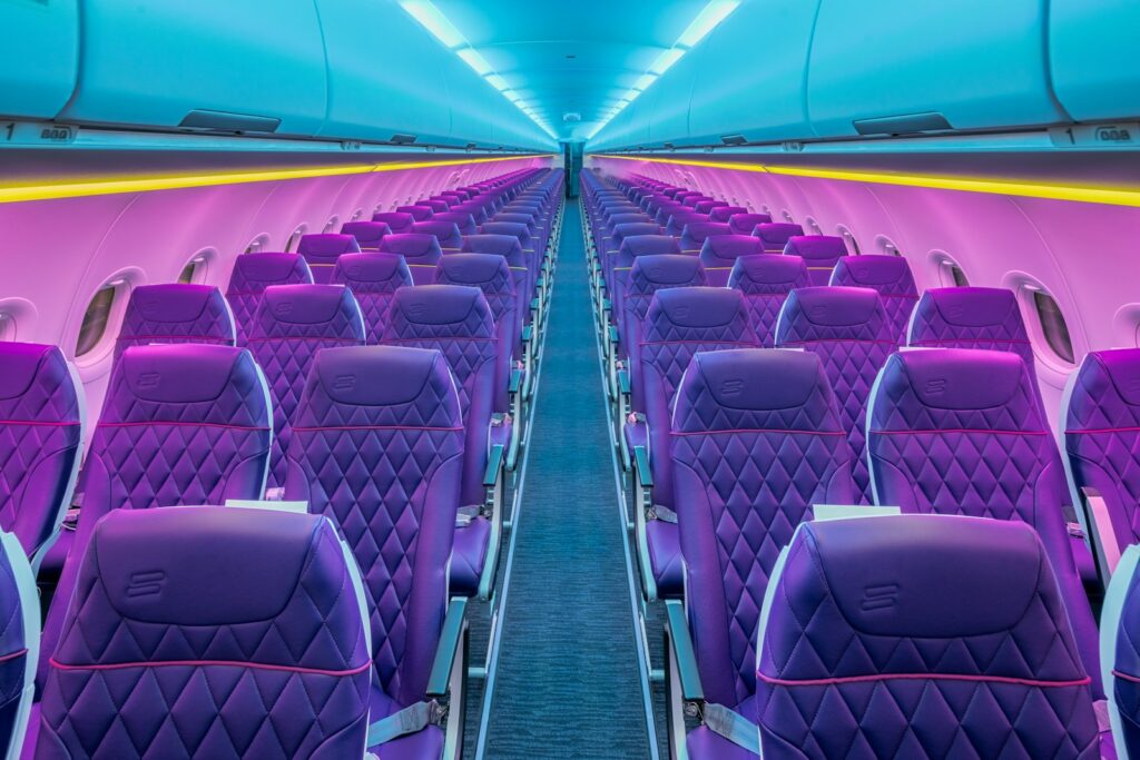 A row of purple seats in an airplane